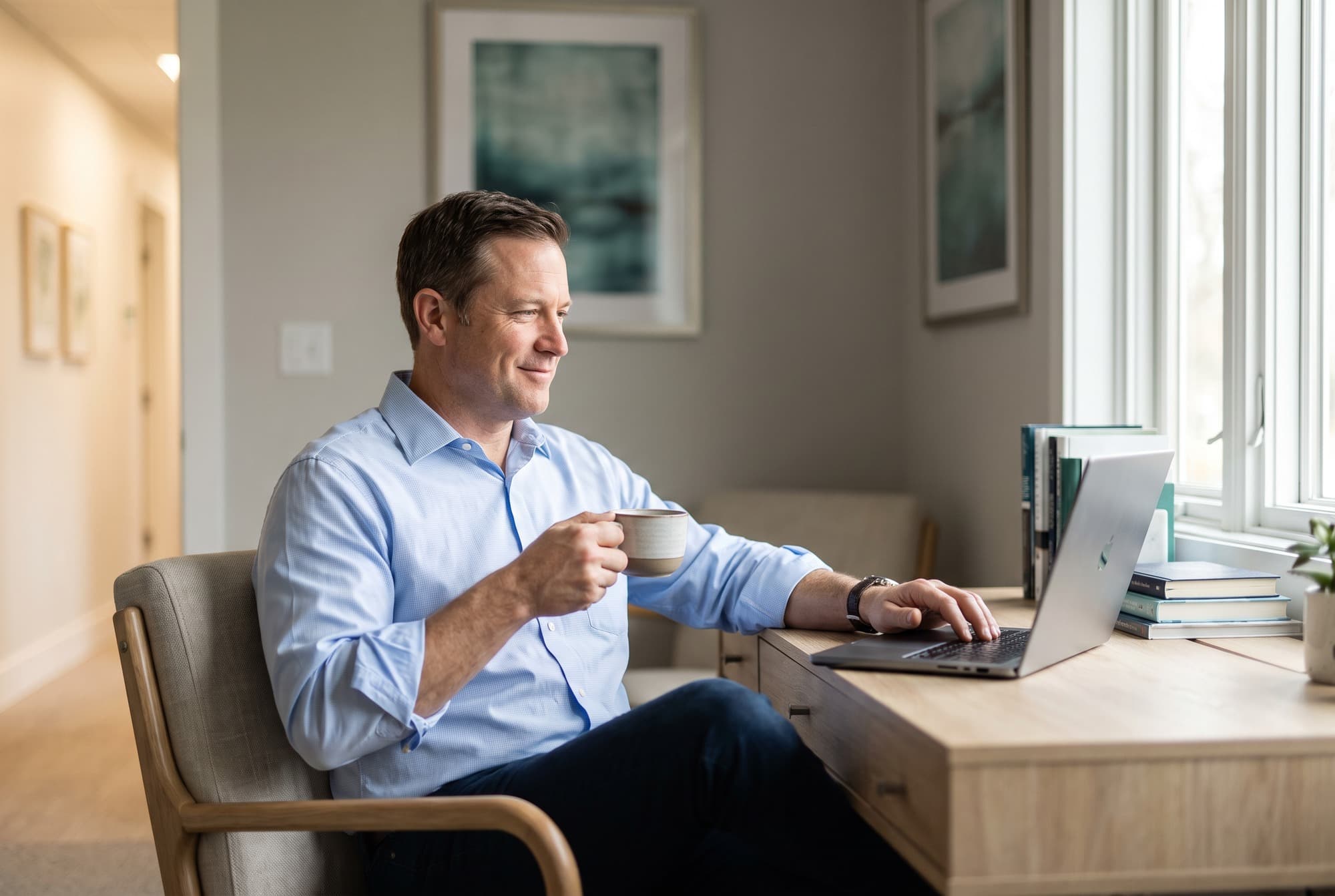A physician-owner reviewing figures on a laptop in his office